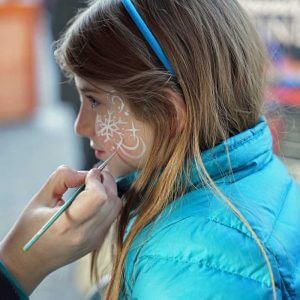 young girl gets her face painted