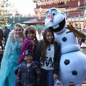 Olaf and disney characters posing for a picture in the village